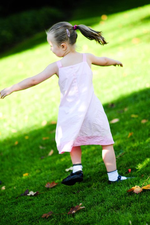 Child playing on a beautifully maintained residential lawn